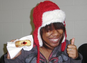 Student in red hat with jelly donut