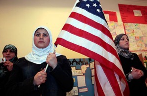 Muslim woman holds American flag