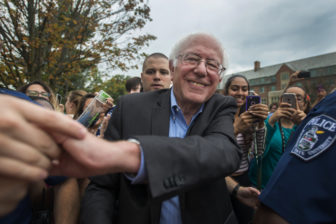 Sen. Bernie Sanders (I-Vt.) shakes hands with a person in the crowd while he makes his exit on Oct. 6, 2016 at Adams Field. East Lansing is one of four locations that Sanders campaigned at on Thursday.  Sanders traveled across Michigan in a campaign for Democratic presidential nominee Hillary Clinton.