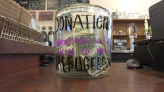 Jar that reads DONATIONS: Proceeds will go to the ACLU to help REFUGEES