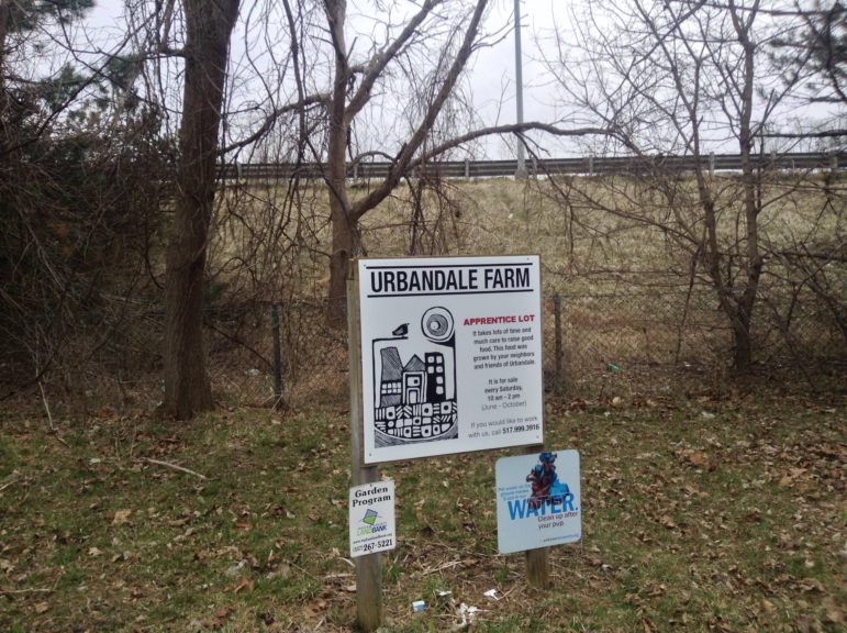 A sign for Urbandale Farm's Apprenticeship Lot stands down the hill Interstate 496 in Lansing. Photo by Maxwell Evans