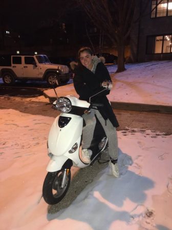 College student on white moped.