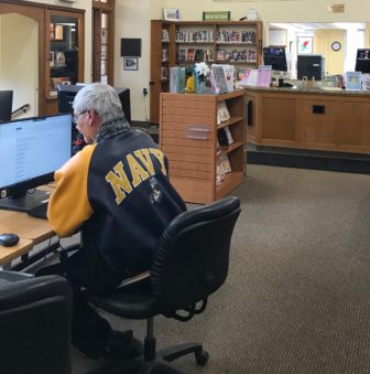 man using computer at library
