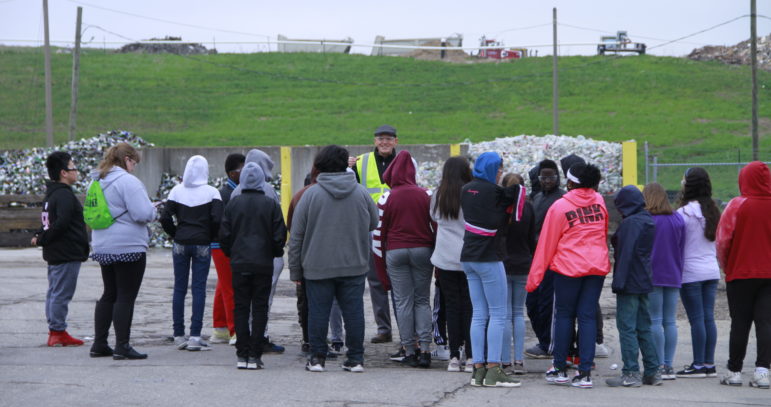 Phillip Mikus, manager of the recycling center at Lansing-based Granger, gives a tour to sixth grade students to show how the company’s recycling center functions and how to utilize the recycling bins correctly.