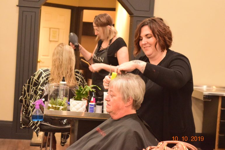 Stylists work with their respective clients.