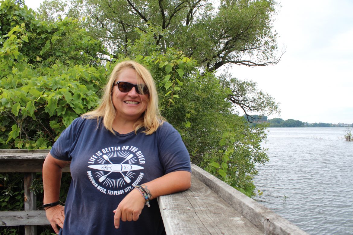 Tawny Miller of River Outfitters in Traverse City by the Boardman River. Credit: Naina Rao.