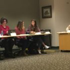 Adele Colson (left) talks to Isabel Abdouch (right) during the first Holt Public Schools Board of Education meeting on Oct. 1. The students serve as advisers to the school board.
