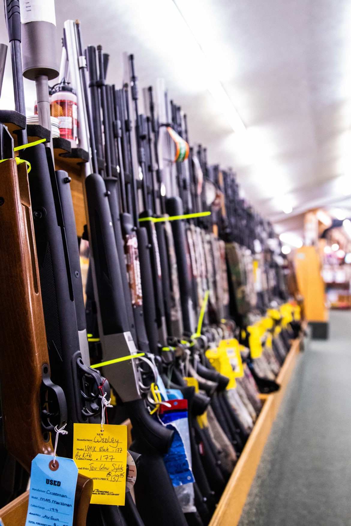 A row of guns are laid out in Total Firearms in Delhi Charter Township on Sept. 24. Total Firearms also features sections for archery and fishing.