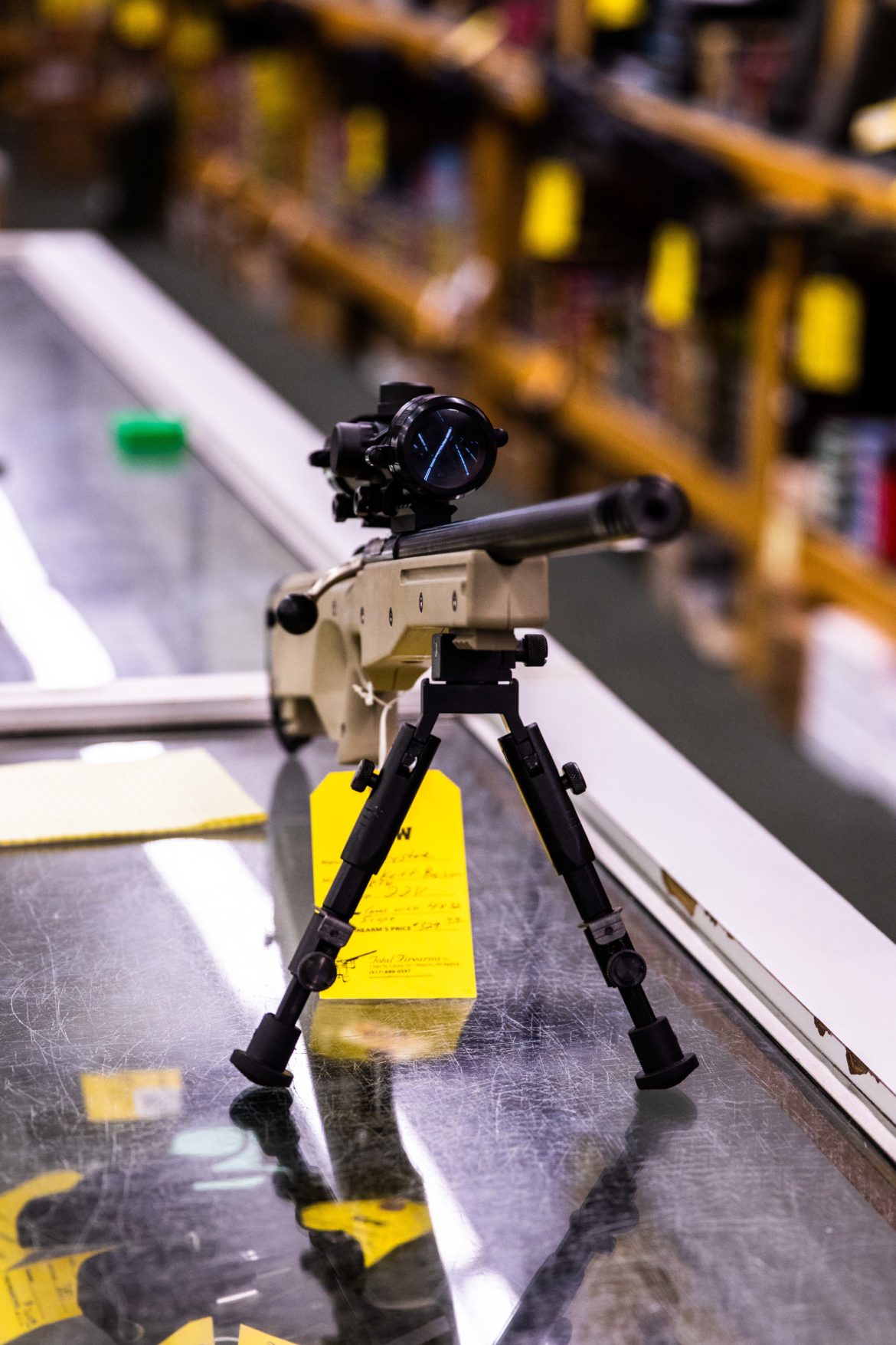 A scoped rifle sits out on the counter at Total Firearms in Delhi Township on Sept. 24. Total Firearms has a section for both a gun range and a gun shop.