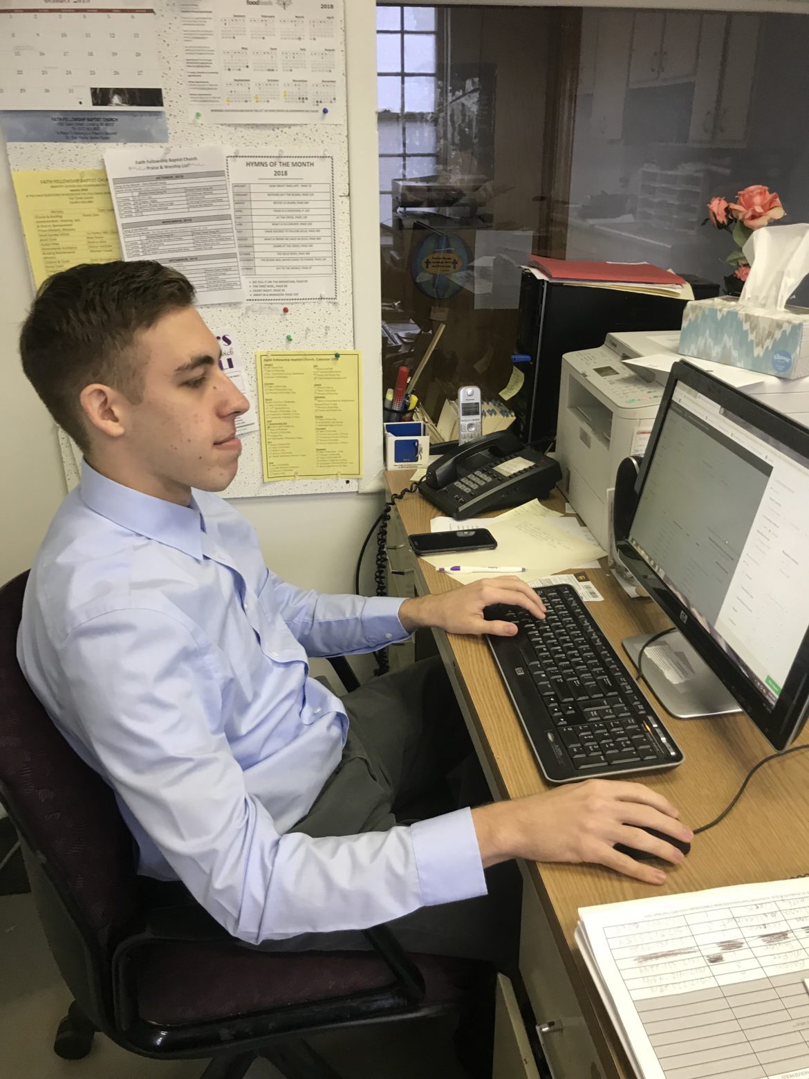 MSU student Logan Parth, an Eastside Community Action Center volunteer, works on financial statements and bookkeeping to gain experience in his field of study, accounting.