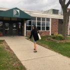 Amara Kzhouz, Dearborn public school teacher, enters her school before a class she takes after school. Schools are facing increasing teacher mobility from teachers switching schools or leaving the profession.