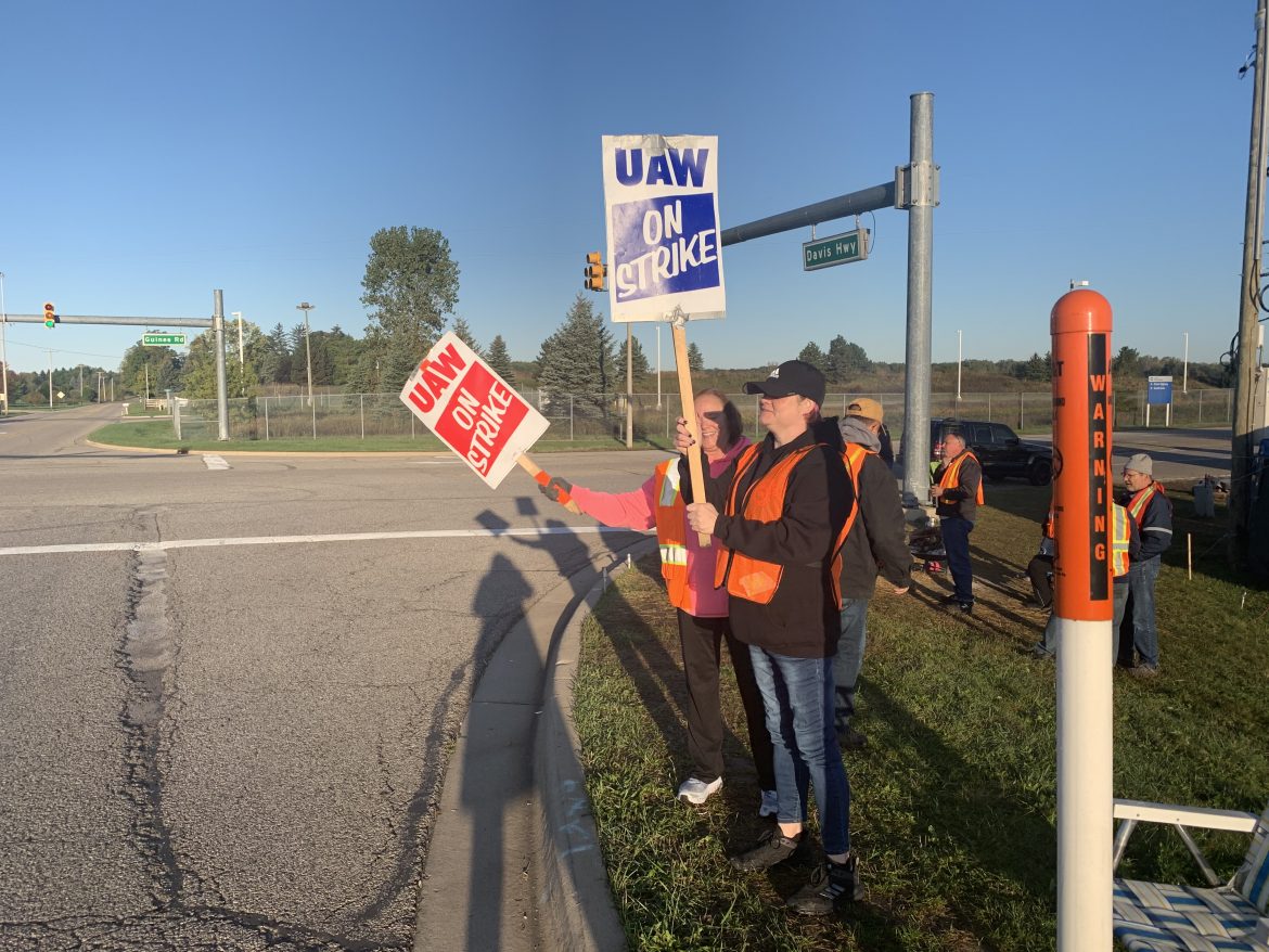 Kathy Berry and daughter Kellie Bowden stand outside General Motors Co.'s Lansing Delta Township Assembly as part of a UAW picket line. The nearly monthlong strike is leading workers to spend less, impacting the local economy.