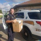 An off-duty Grand Ledge police officer in uniform delivers lunch to those who couldn’t make it out to Bye Financial Group. Food deliveries were made to donors throughout the entire event. Photo used with permission. Photo Credit: Grand Ledge Police Department