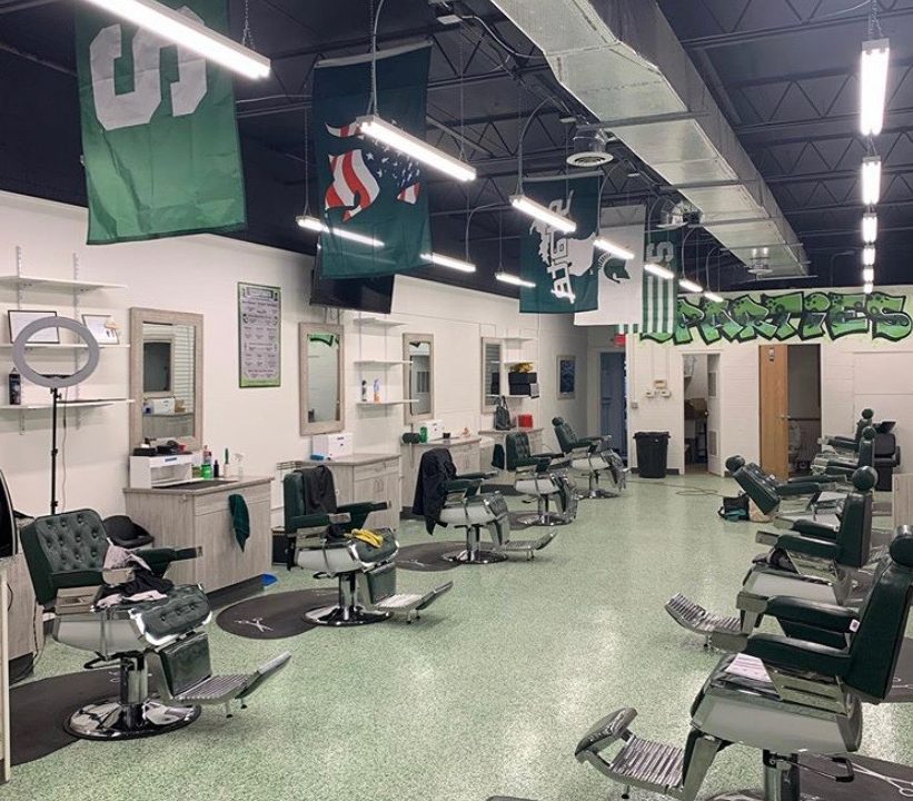 Empty barbershop with about a dozen chairs