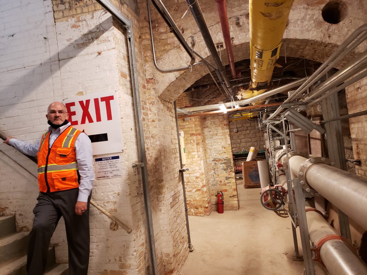 Rob Blackshaw, director of operations for the Michigan State Capitol Commission, walks through the Capitol’s former basement boiler room, which now contains equipment for the building’s new geothermal heating and cooling system.