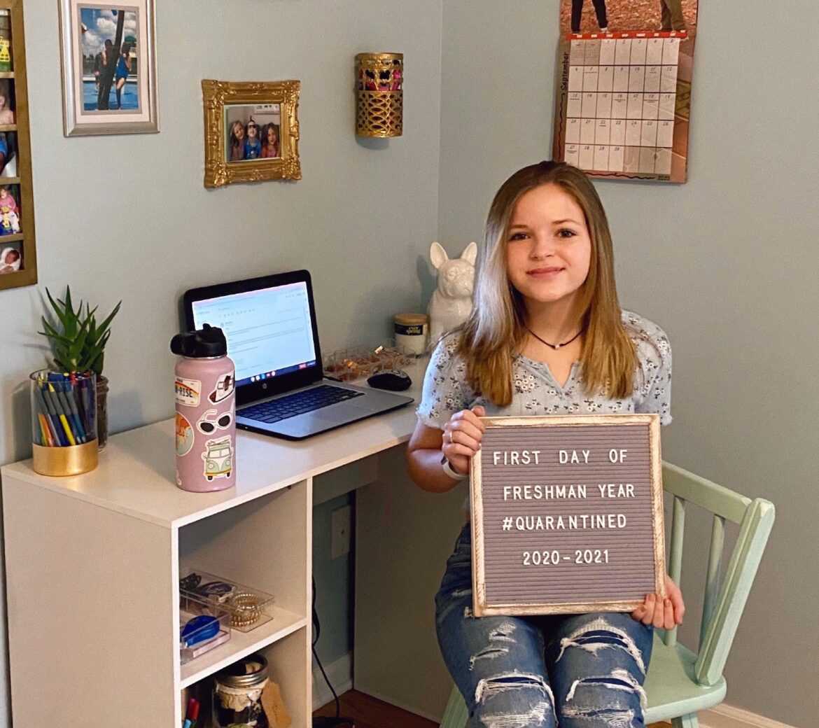 Jordan Fields, a freshman at Grand Ledge High School, sits at her desk at home for a photo marking the first day of school. Grand Ledge students are spending the first trimester online.