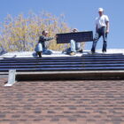 Installation of the roof-integrated solar panels on John Sarver’s East Lansing home in 2010. These were the only panels he used until 2019 when he added additional traditional style panels.
