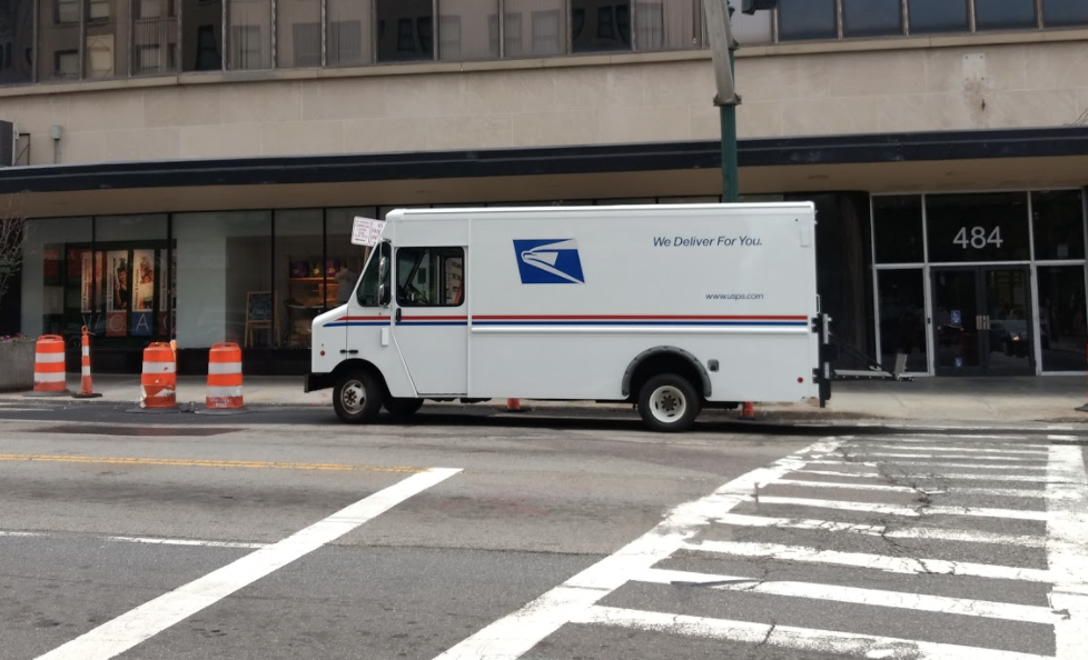 U.S. Postal Service truck stopped at building