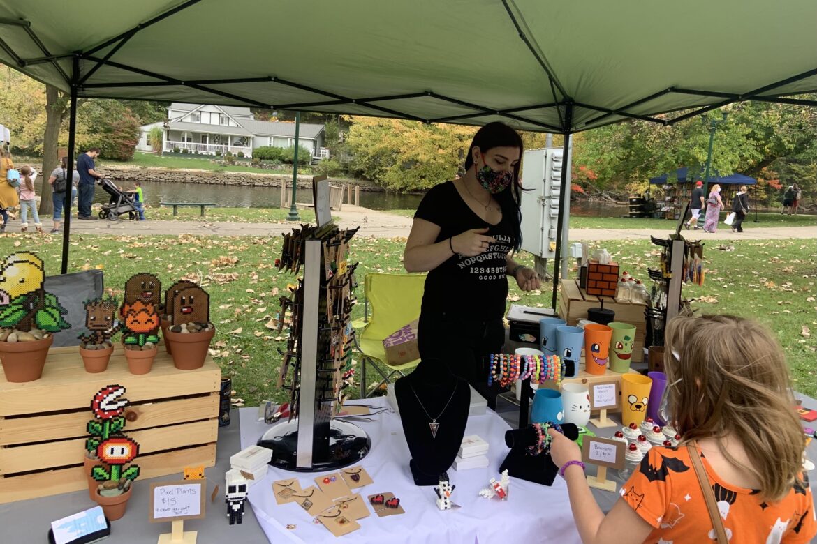Megan Cote, the owner of Reverie Castle Studios, sells her creations at the 2020 Fall Festival in Grand Ledge on Saturday, Oct. 10. Cote usually sells her products at the Island Art Fair, however, this event was canceled due to COVID-19.