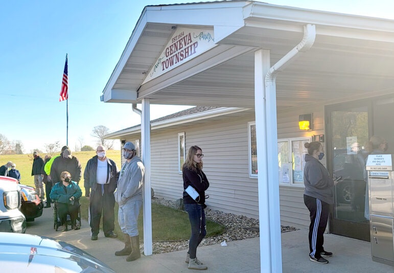 Voters line up outside of the Geneva Township Hall, near South Haven in southwest Michigan, on Tuesday. State and local election officials expect a possible record turnout between absentee ballots and in-person voting.