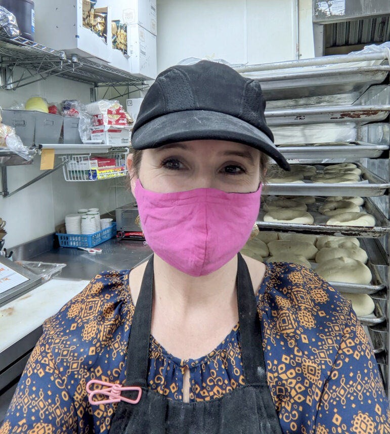 Bethany Augustine posted herself smiling under a mask on Flour Child Bakery’s Facebook page after donating 800 bagels to essential workers.