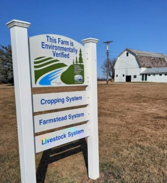 A sign on Allen Family Farms in Owosso shows the farm has met environmentally friendly standards under a state program.