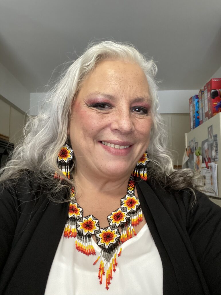 Tribal Elder Randi McKinney wears traditional Native American jewelry at her home.