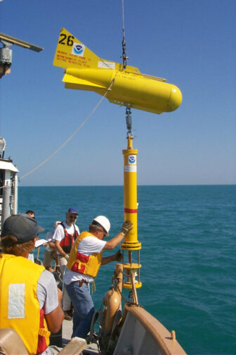 Scientists deploy a cable with temperature sensors in Lake Michigan.