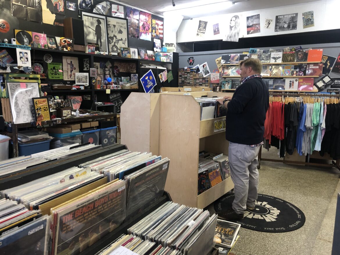 Customer Justin Allen browses through the new arrival bin at The Record Lounge in REO Town.