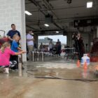 a firefighter and child put out a fire using a fire extinguisher