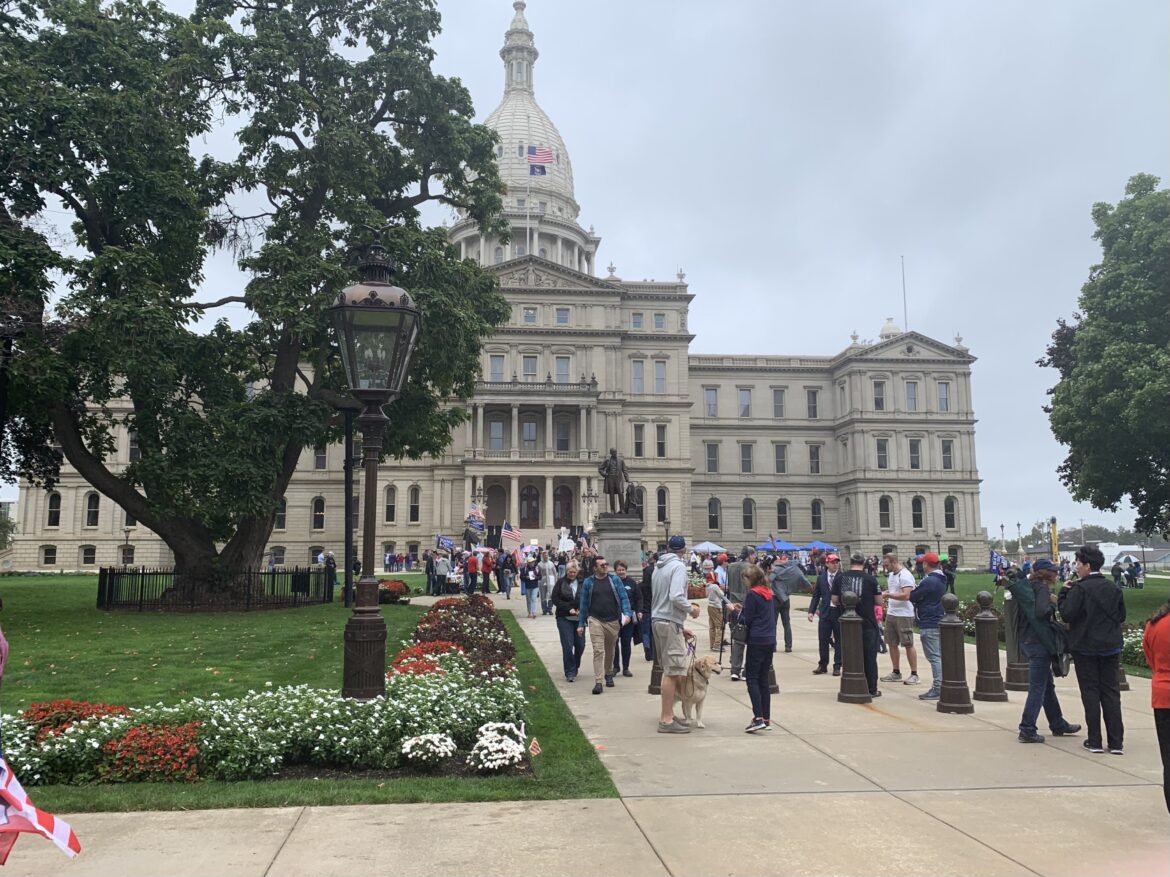 Protesters stand outside the state Capitol on Oct. 12 requesting an audit of the 2020 election results.
