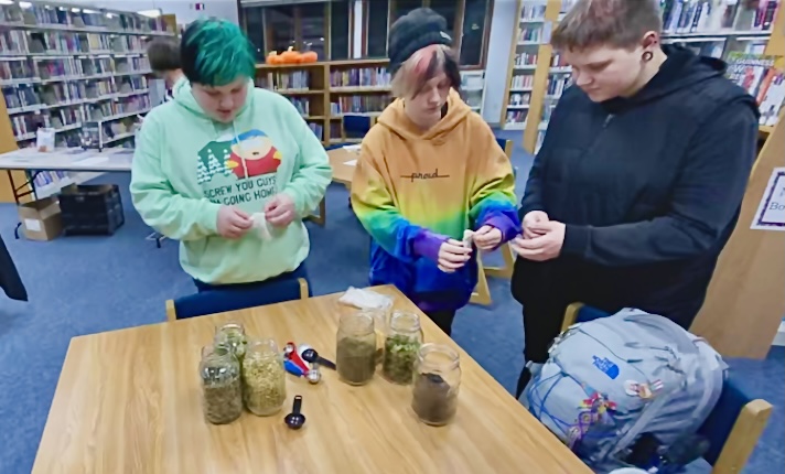 Community members prepare custom tea blends using hand-picked herbs provided by author Bevin Cohen at a recent presentation at the Briggs District Library in St. Johns.