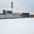 A dusting of snow covers the East Grand Rapids High School football stadium.