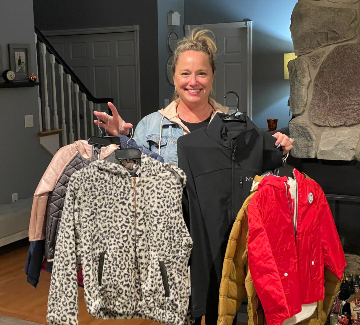 Julie Knop displays what coats she has left to give away.