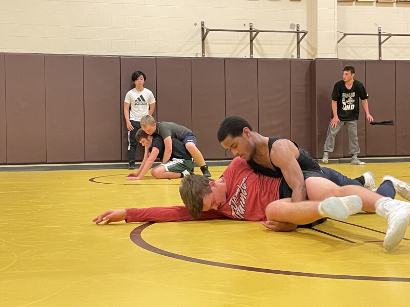 Senior Grant Bachman gets held down by his opponent during a practice Nov. 16.