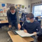 Andrew Lambert assists a student in his history class.