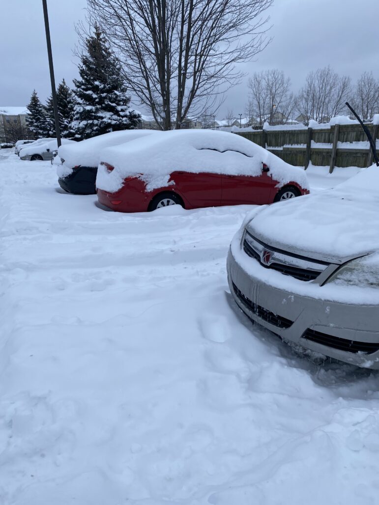 Snow covers parked cars