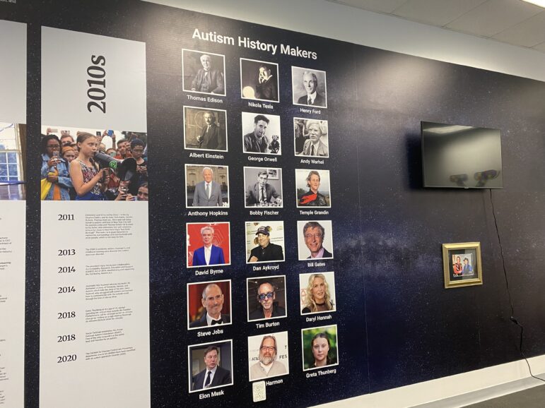 Prominent figures on the autism spectrum are displayed on the museum wall.