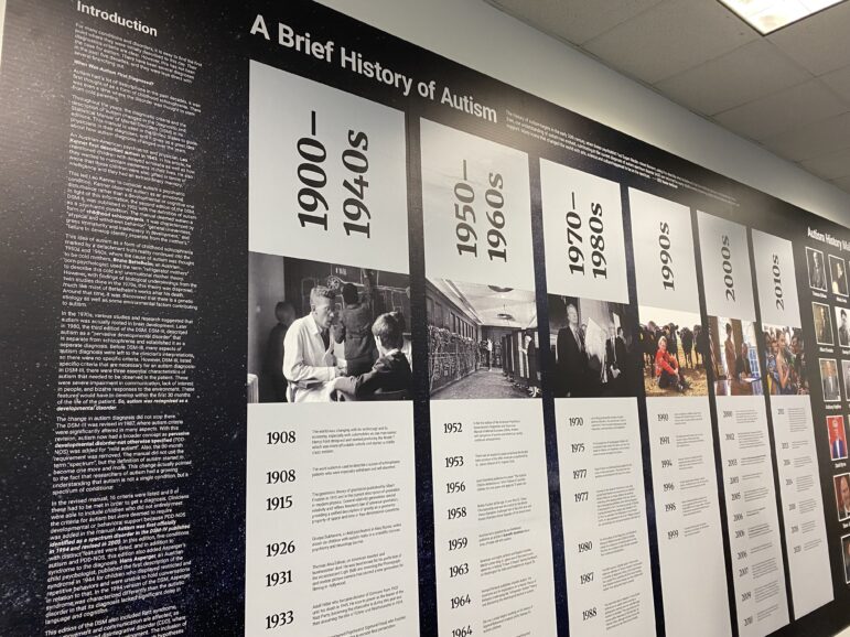 A timeline of autism's history is displayed on the museum wall.