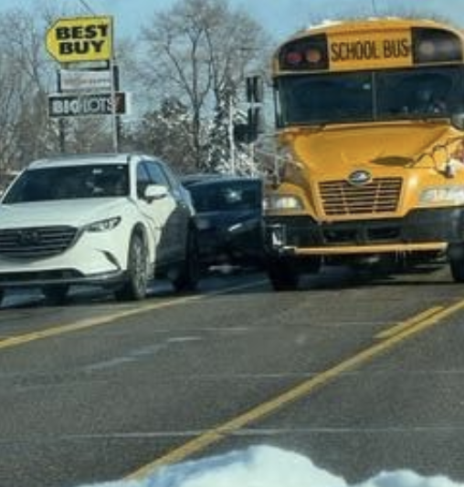 A bus and a car travel next to each other