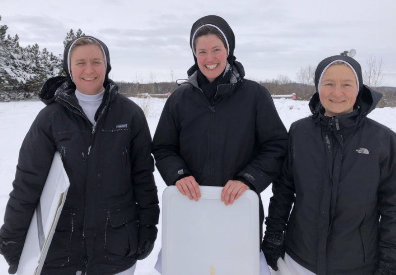 Three nuns at sledding hill