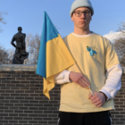 College student outdoors with Ukrainian flag