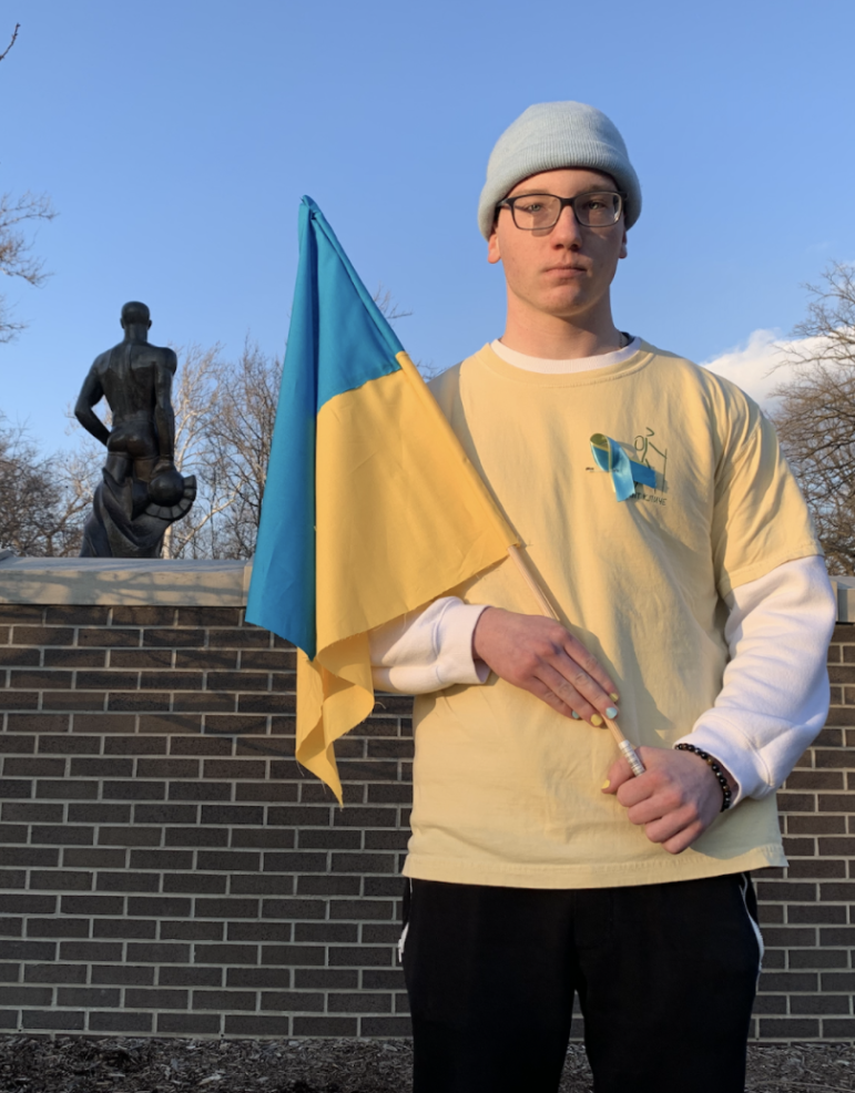College student outdoors with Ukrainian flag