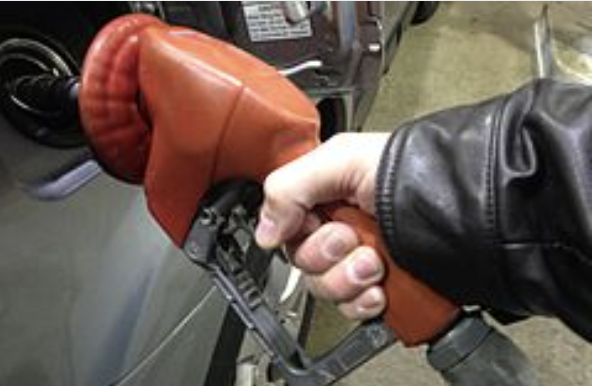 Hand of man pumping gas