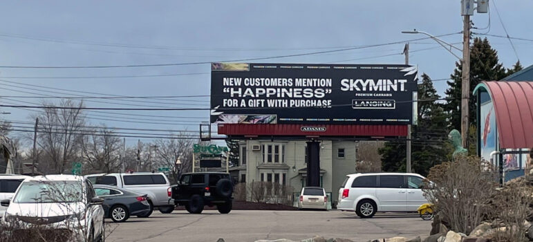 A Skymint billboard stands in the parking lot of Preuss Pets in Lansing.