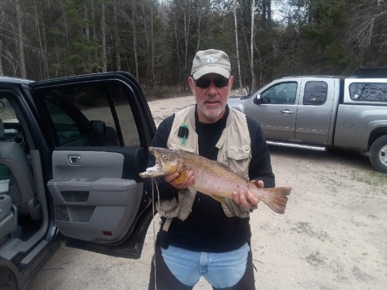 Tim Mulherin with a 6.5 pound brown trout on the Jordan River on the opening day of trout season.