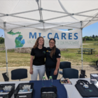 Community activists at the Pittsfield Farmers Market offer information about MI-CARES.