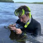 Undergraduate researcher Michael Hillary measures a mussel.
