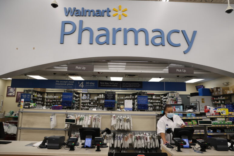Bianca Doniver, manager of the pharmacy at Walmart in White Lake, works on a computer at the retail counter of the pharmacy
