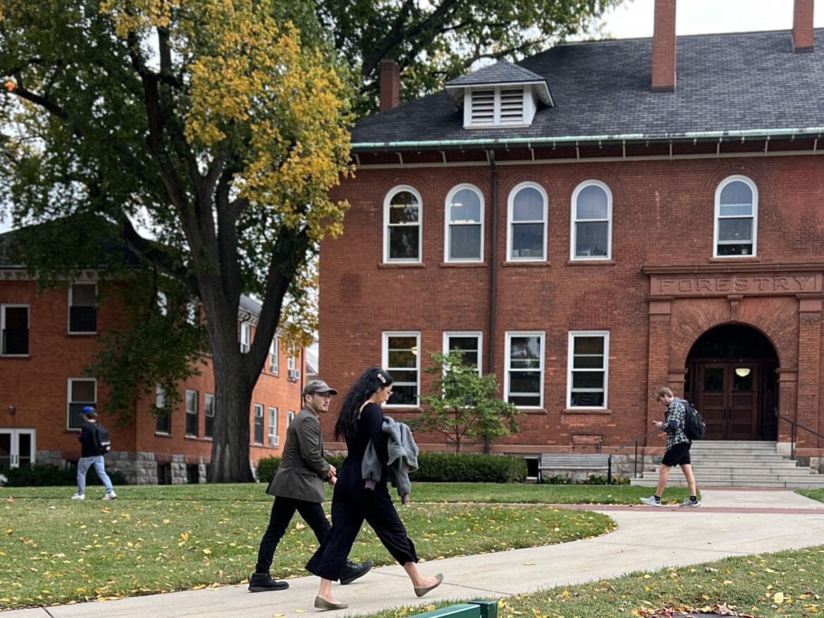 Michigan State University students walk near Chittenden Hall, the home of graduate school.